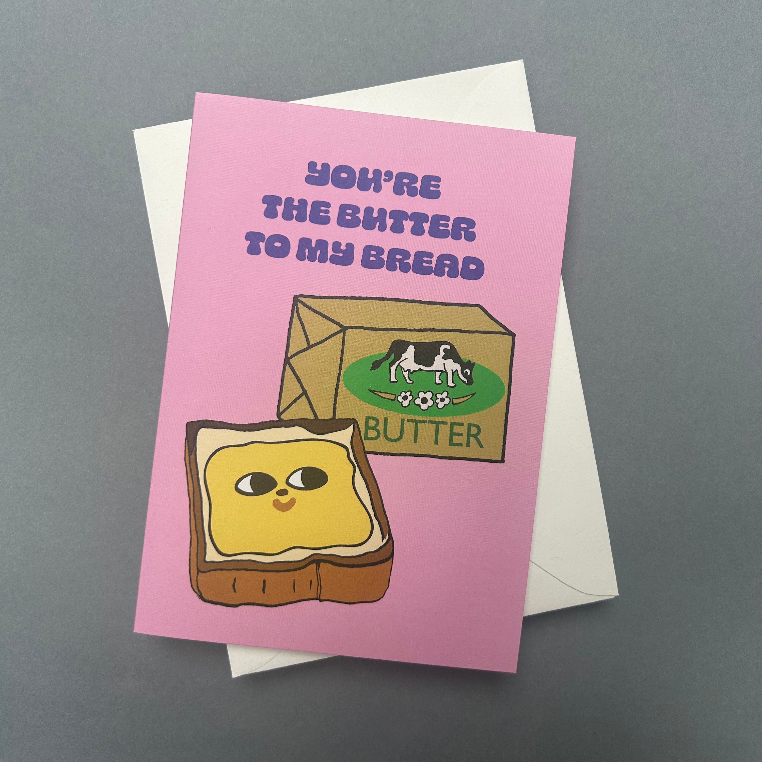Greeting card with cartoon toast and butter design on a pink background