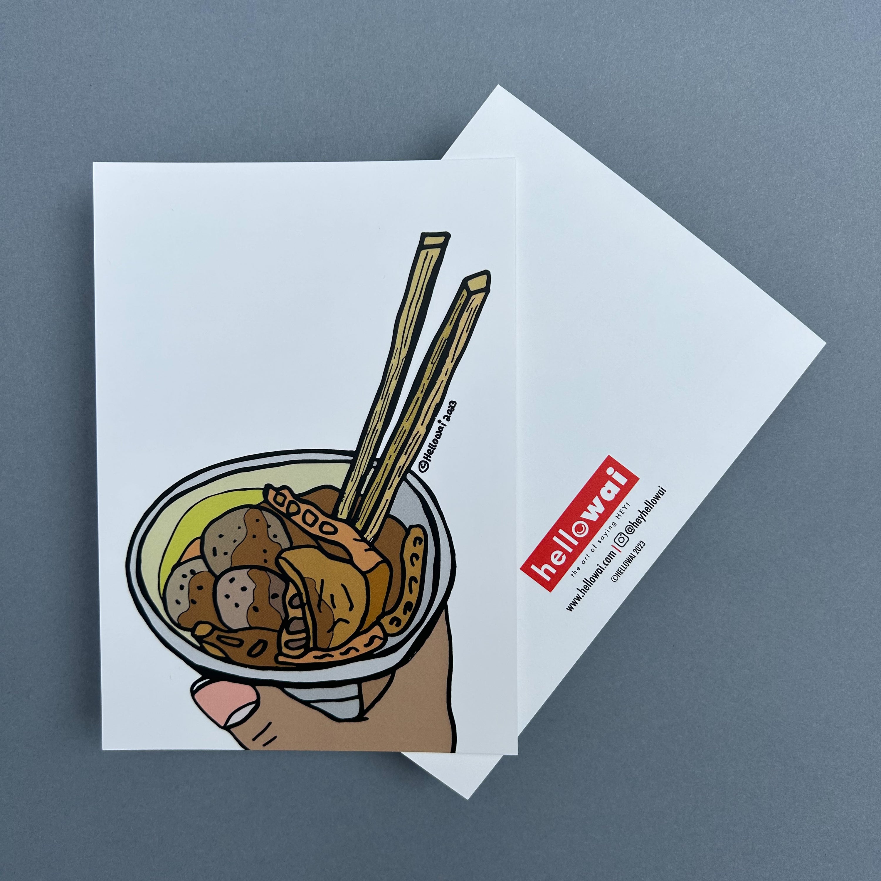 Front and back view of an A6 Hello Wai flat notecard. Front has colour illustration of a cup of curry fish ball and chopsticks, printed on white card. Back has the Hello Wai logo.