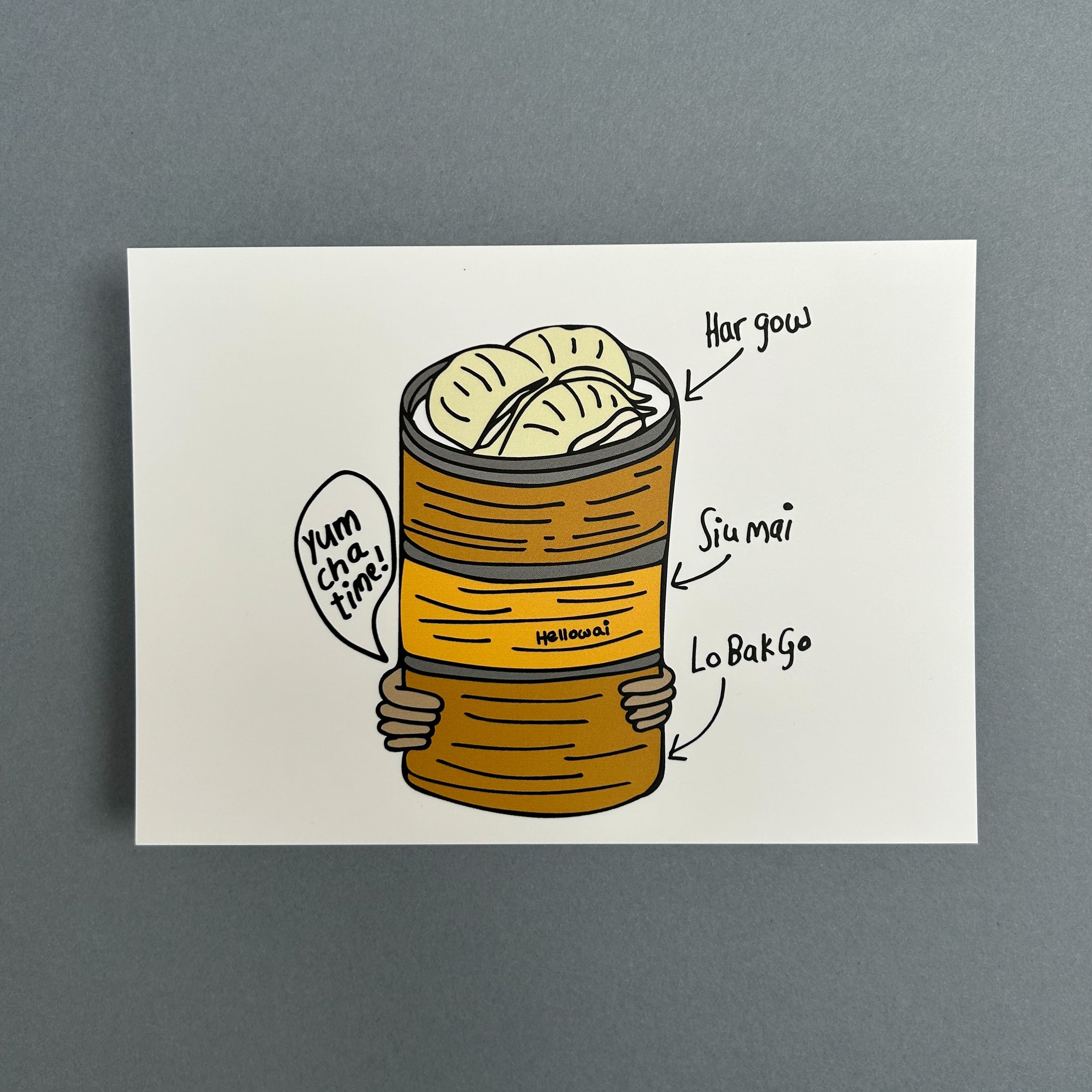 An A6 Hello Wai flat notecard with a colour illustration of pair of hands carrying three bamboo baskets stacked with dim sum, the top basket has har gow, printed on white card.
