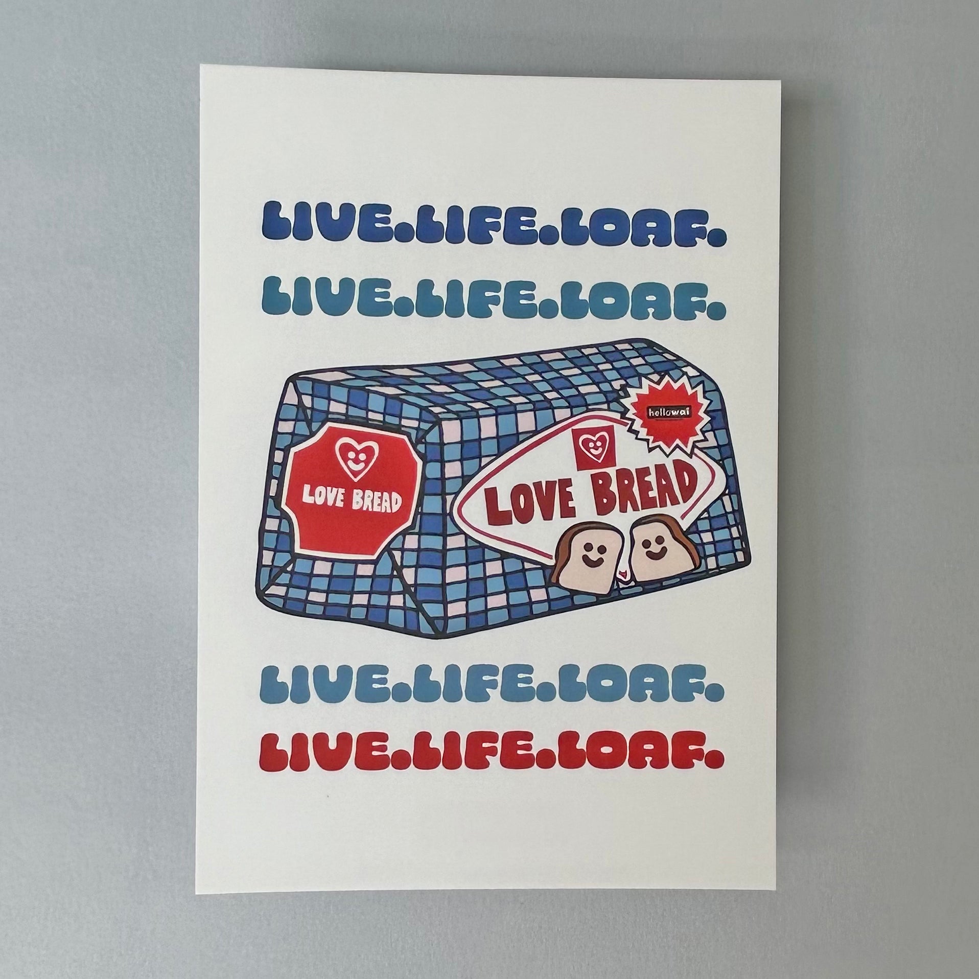 A notecard with a blue and white gingham background featuring a cartoon loaf of bread with the text 'LIVE.LIFE LOAF' and the name 'Love Bread' on it.