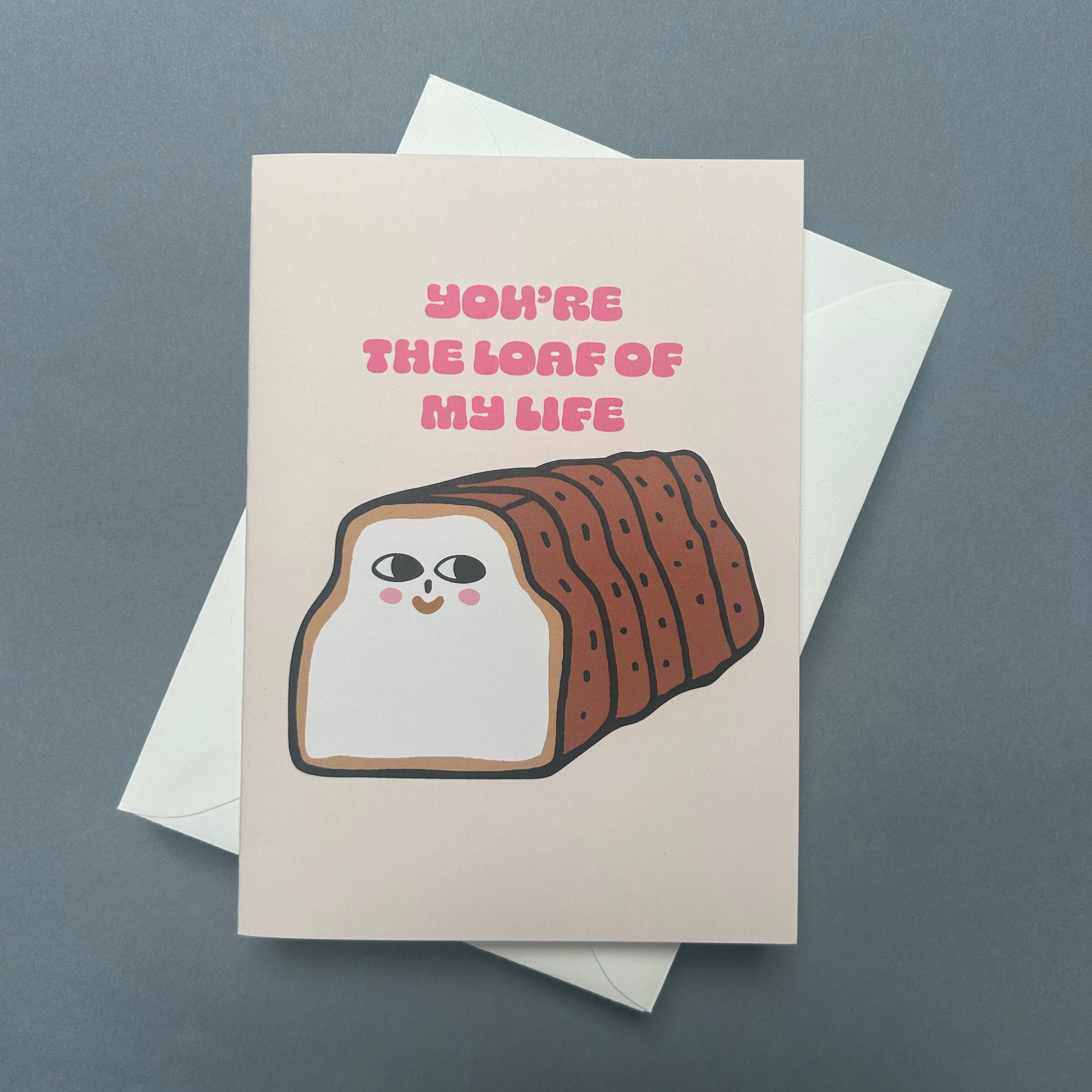 Greeting card with a loaf of bread illustration and text on a gray background