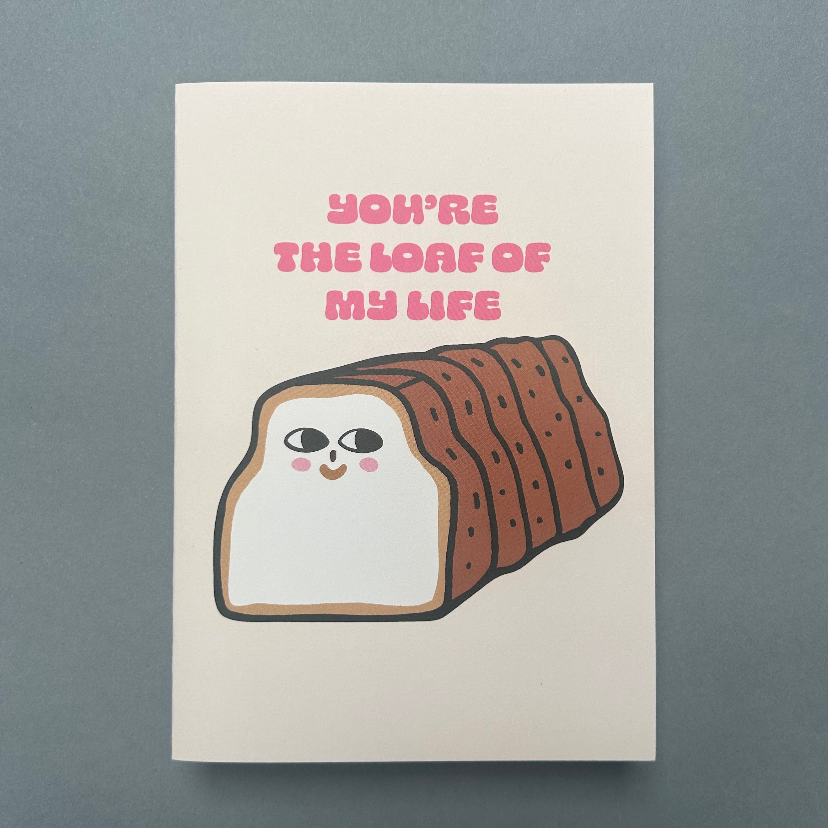 Card with a loaf of bread illustration and text on a gray background