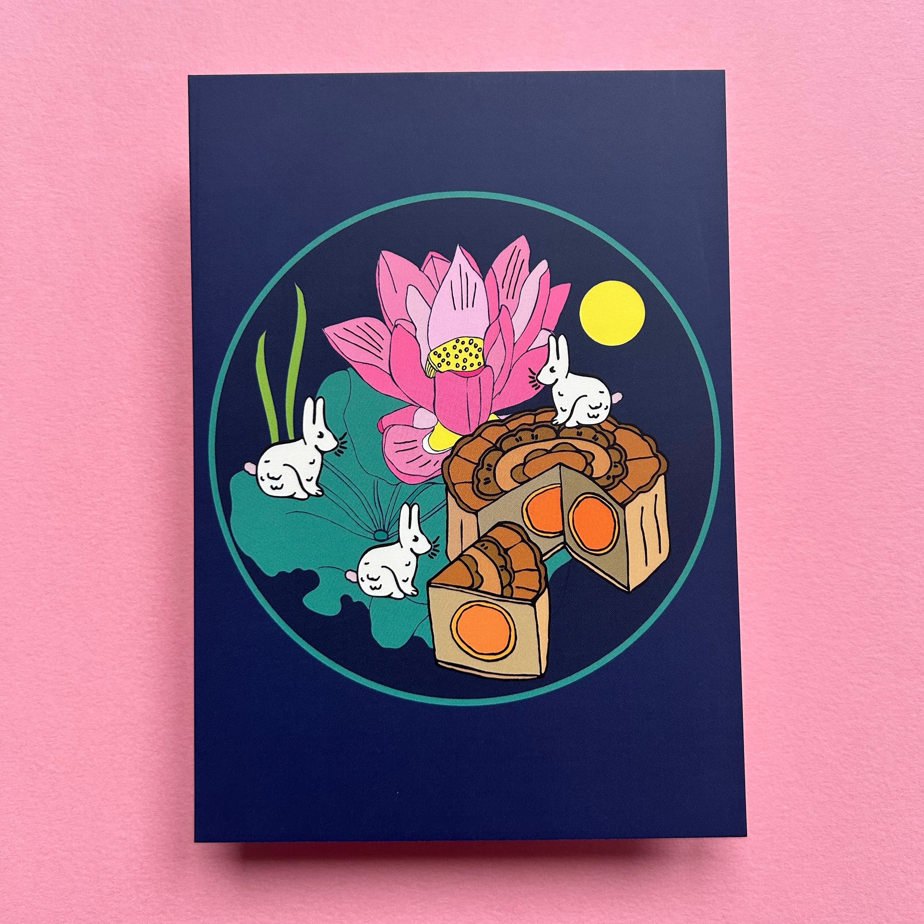Illustration of a pink lotus flower with rabbits and mooncake on a blue background