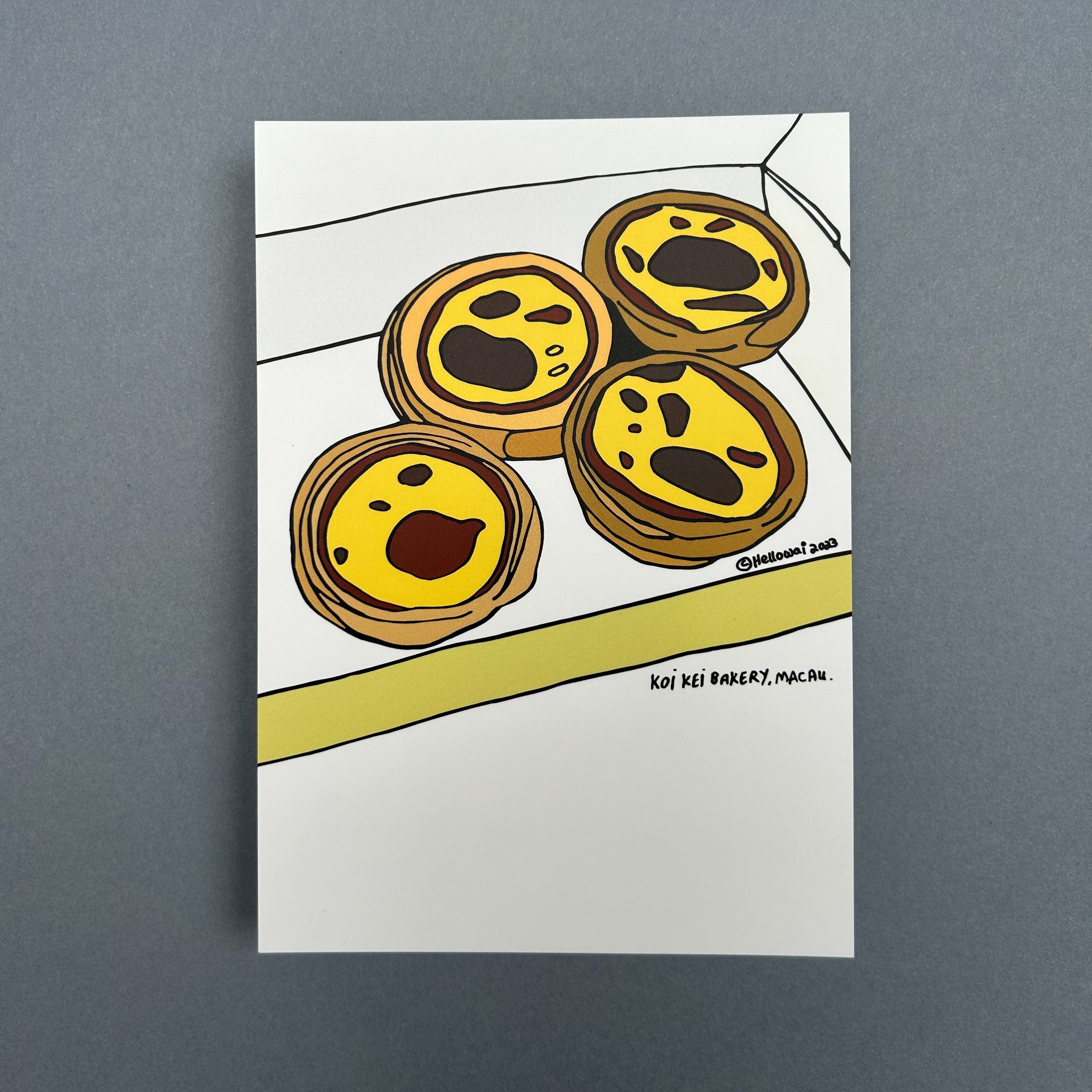 An A6 Hello Wai flat notecard with a colour illustration of four Portuguese egg tarts in an open box, printed on white card. 