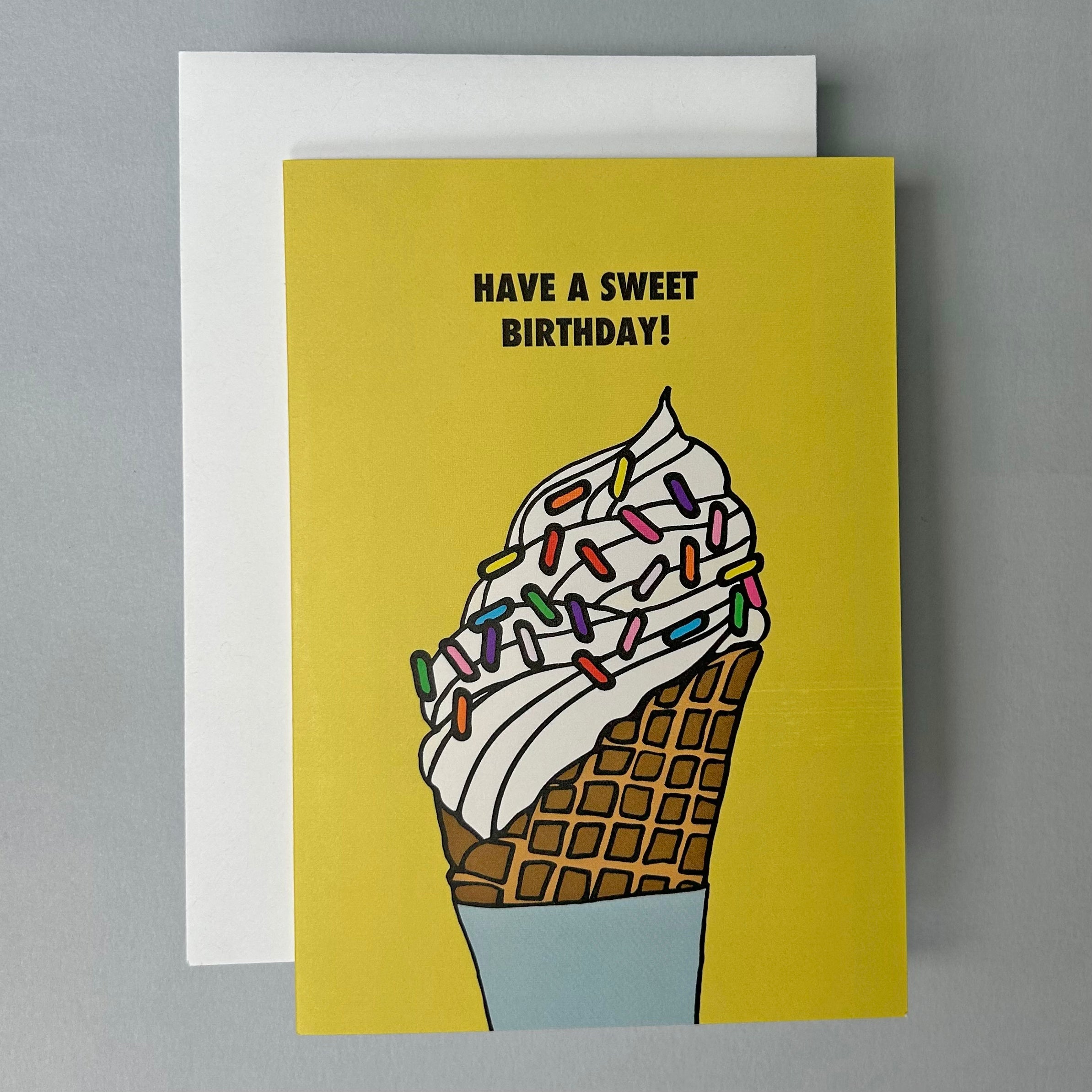 Greeting card with ice cream cone and rainbow sprinkles illustartion and 'Have a sweet birthday!' text on a yellow background.