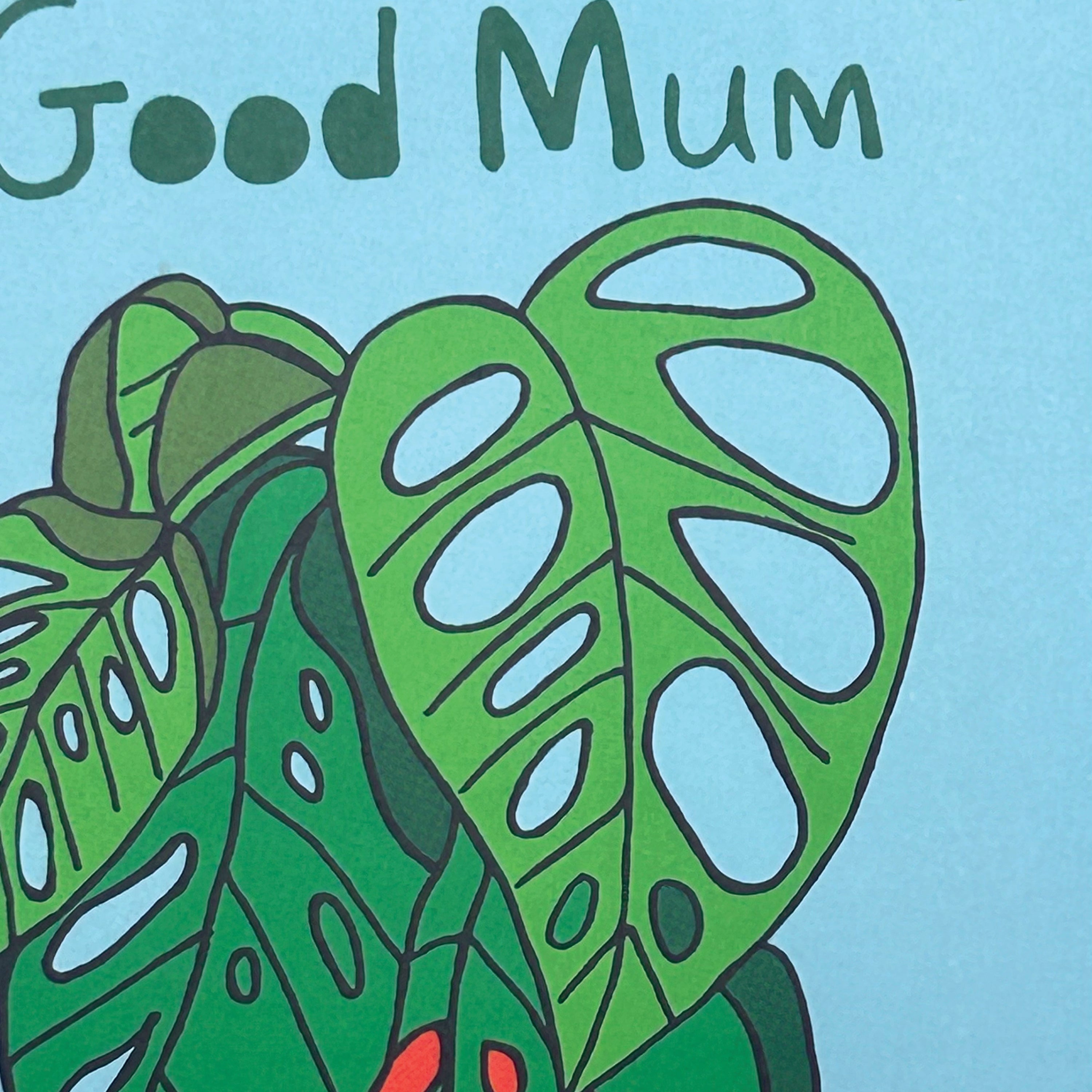 Illustration of green leaves with 'Good Mum' text on a light blue background