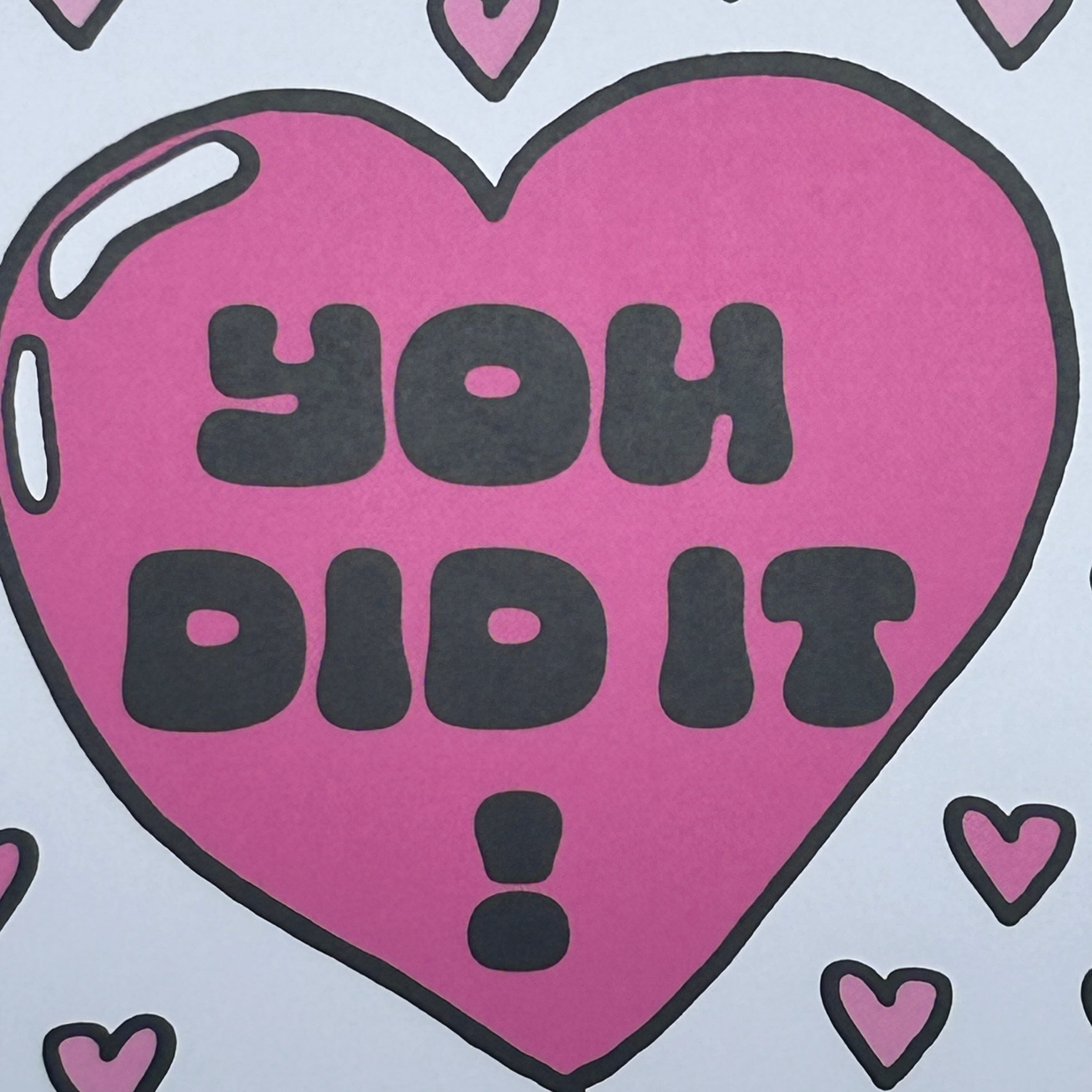 Purple heart with 'YOU DID IT!' text on a light blue background with smaller hearts.